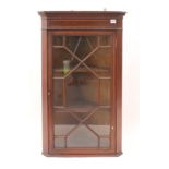 An Edwardian inlaid mahogany corner cupboard