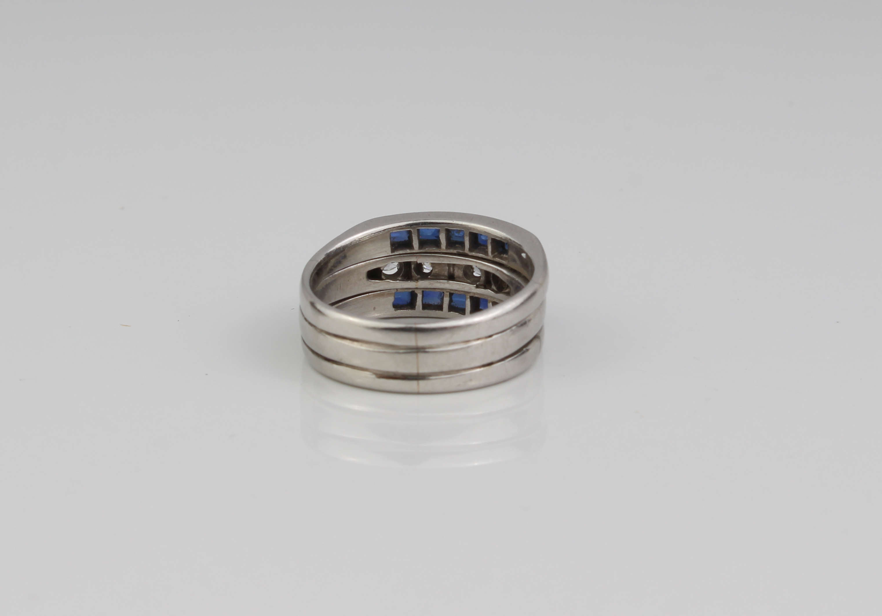 A platinum, sapphire and diamond three-row ring - unmarked, tested as platinum, the central row of - Image 2 of 4