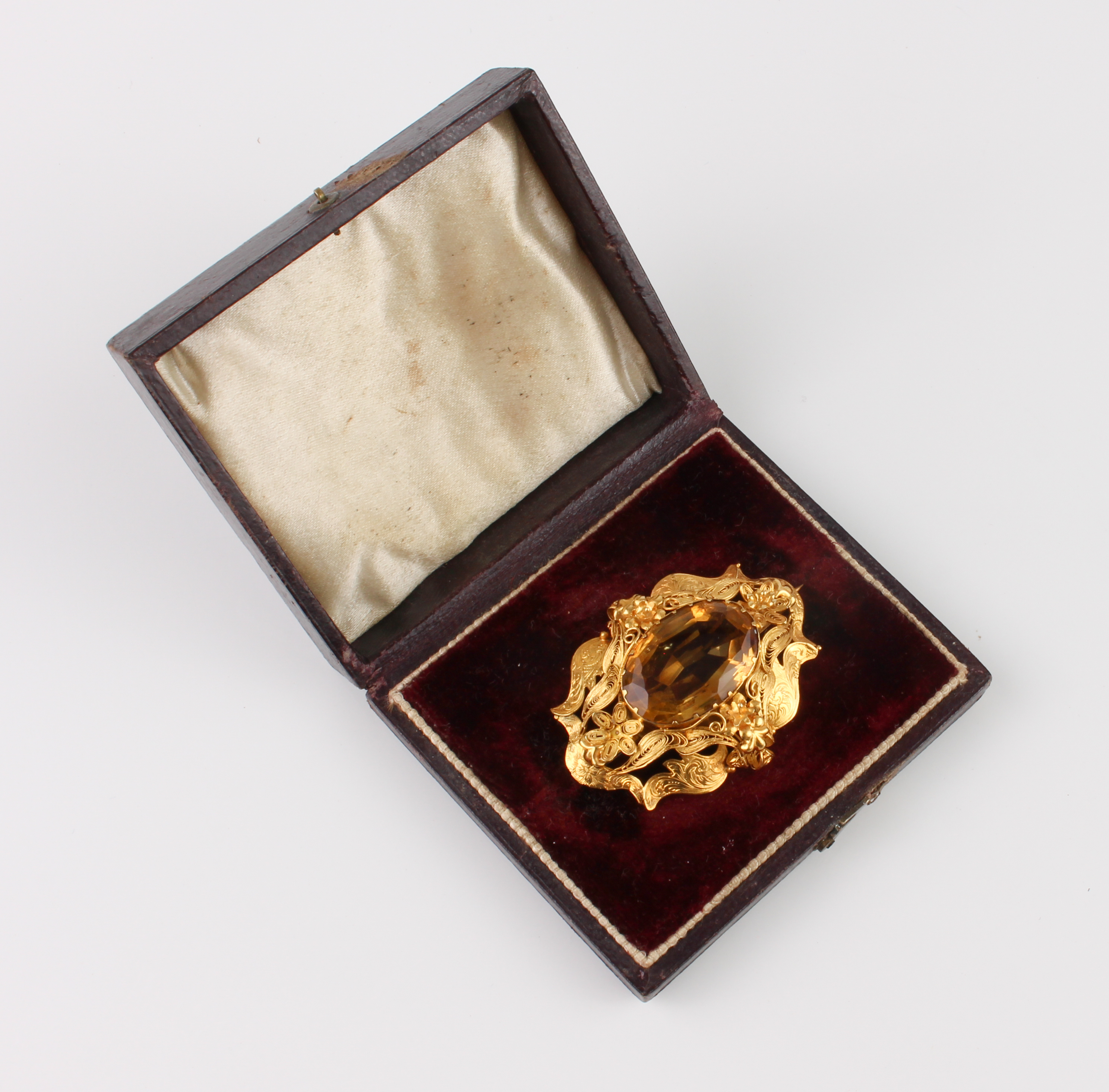 A mid-19th century 18ct gold and citrine brooch - the 21.5 x 14.5mm oval, mixed cut citrine