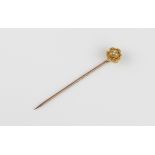 A cased Victorian yellow and rose gold and diamond stick pin - the 18ct yellow gold daisy head set