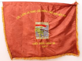 A Vietnam War Viet Cong silk victory flag - embroidered with an image of a soldier to the centre,