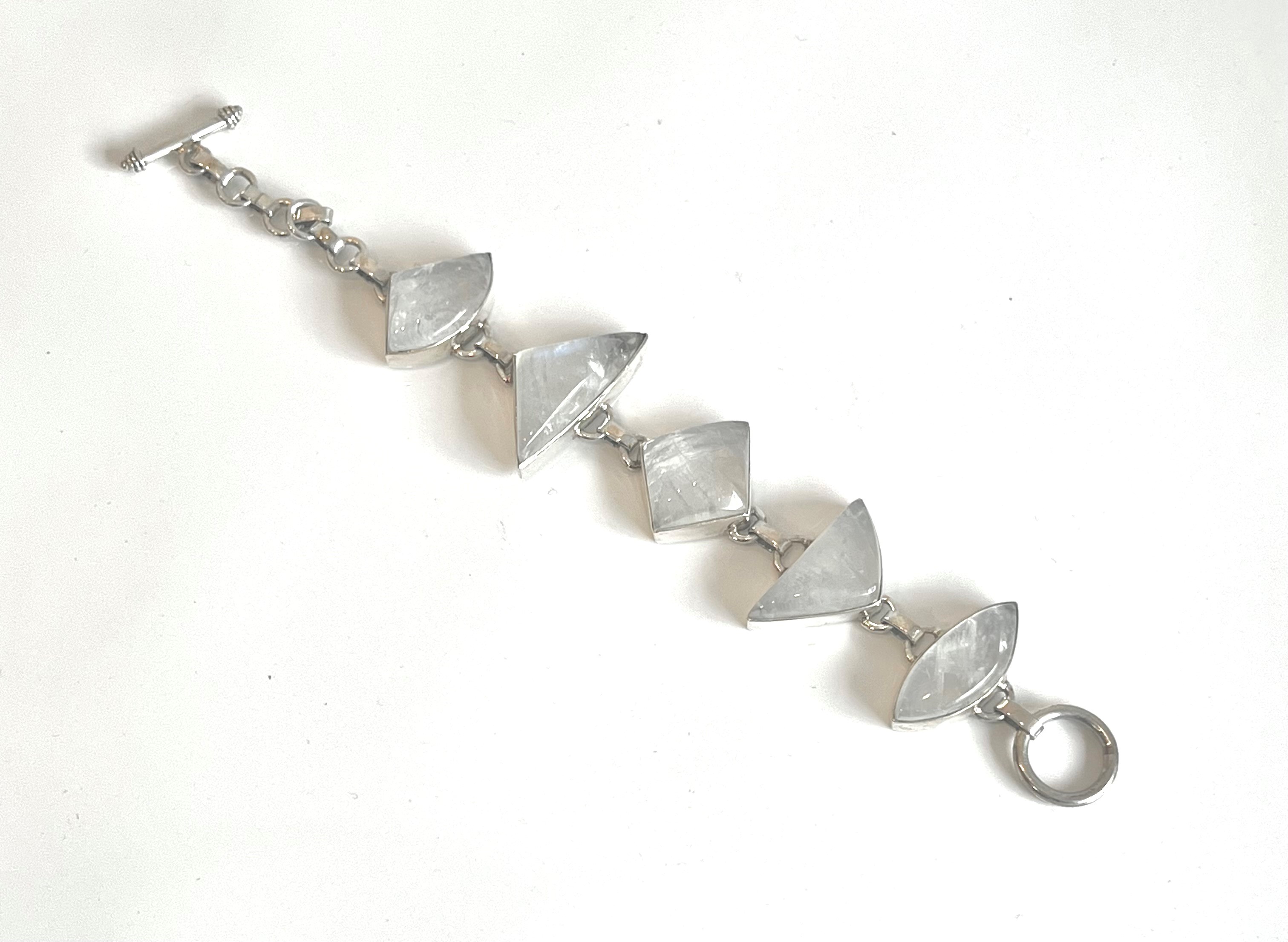 A silver and moonstone bracelet - with five different geometrically shaped cabochon moonstones in