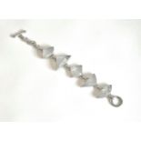 A silver and moonstone bracelet - with five different geometrically shaped cabochon moonstones in