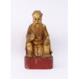 A Chinese carved and gilded wooden deity figure - probably early 20th century, with red lacquered