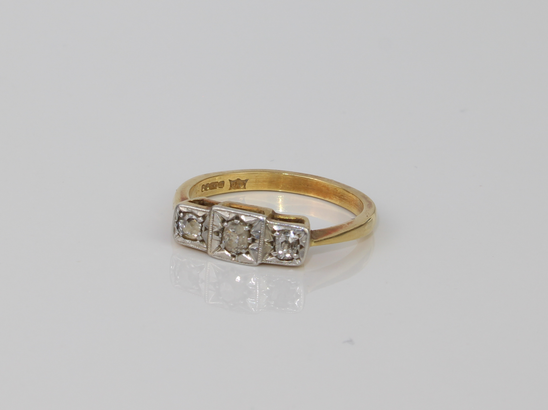 A mid-century style 18ct yellow gold and diamond three stone ring - hallmarked Birmingham 1985, with