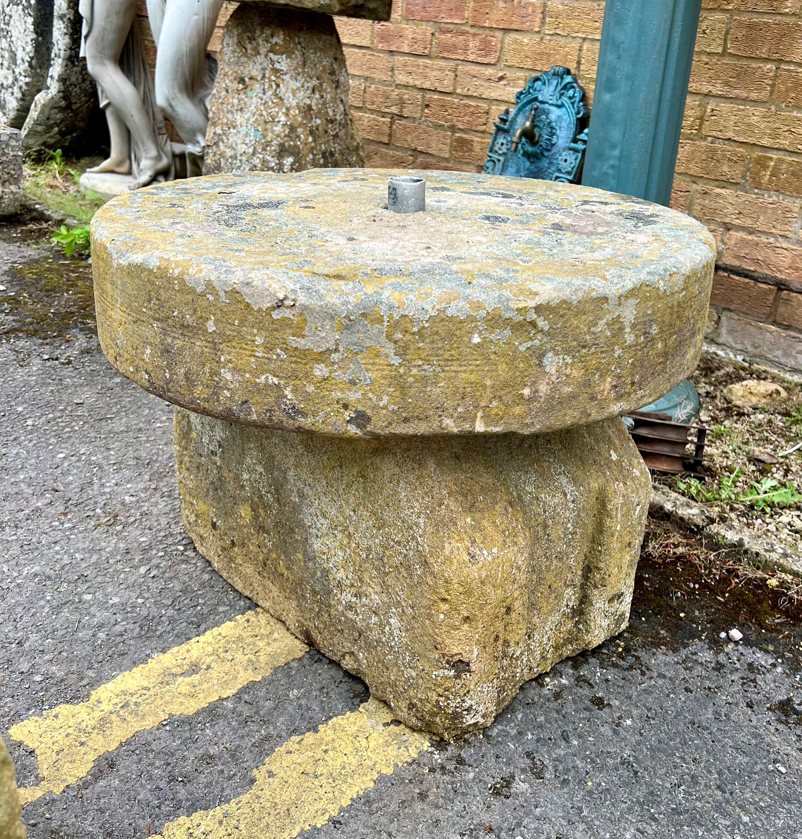 A water feature base - with a circular grinding stone and on a shaped base. Base: 50cmW x 31cmD x