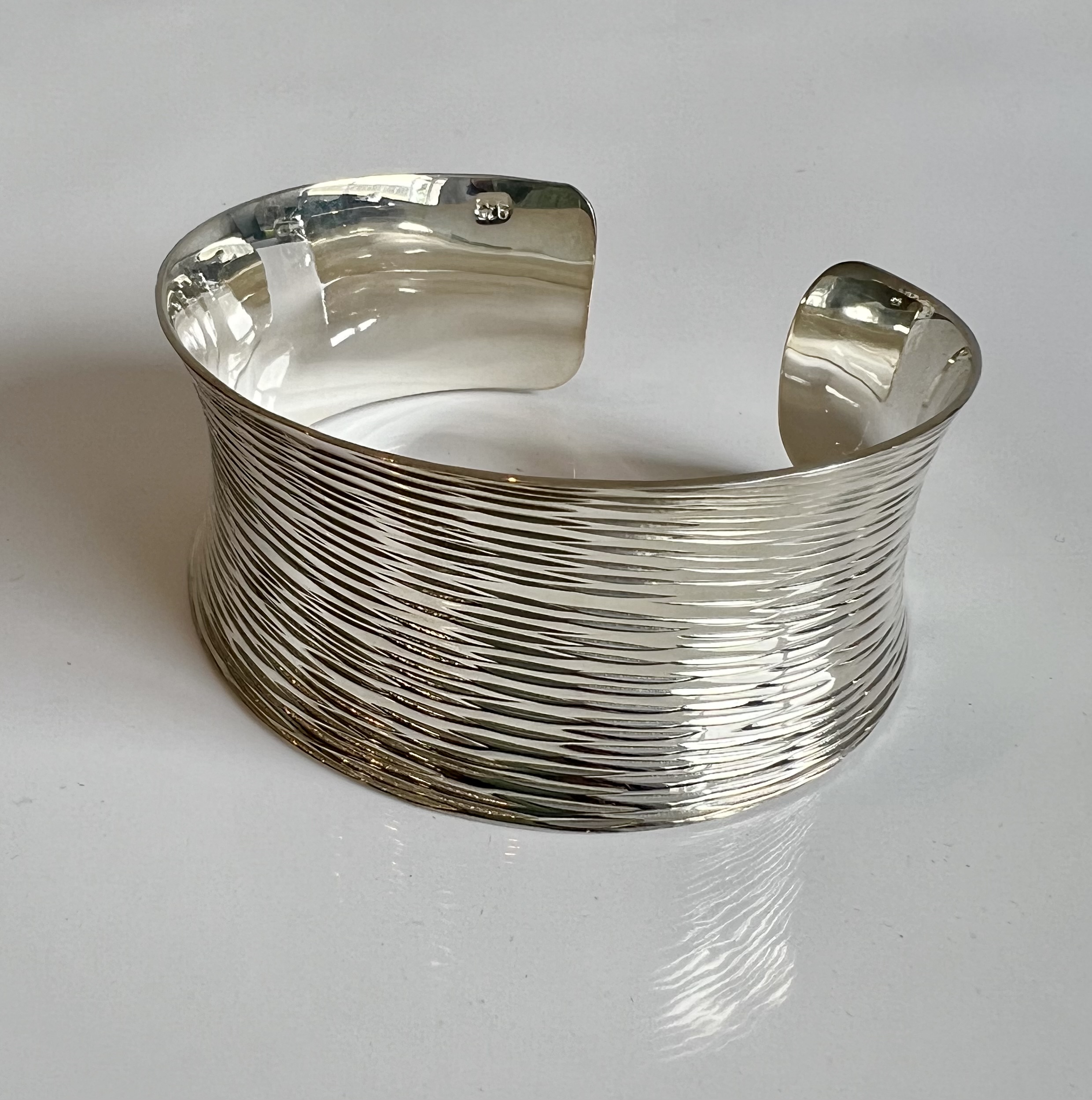 Three modernist sterling silver bangles - each stamped 925, comprising a bark effect cuff bangle, - Image 2 of 4