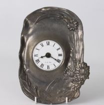 An Art Nouveau style pewter clock - late 20th century, of shaped form with floral decoration to