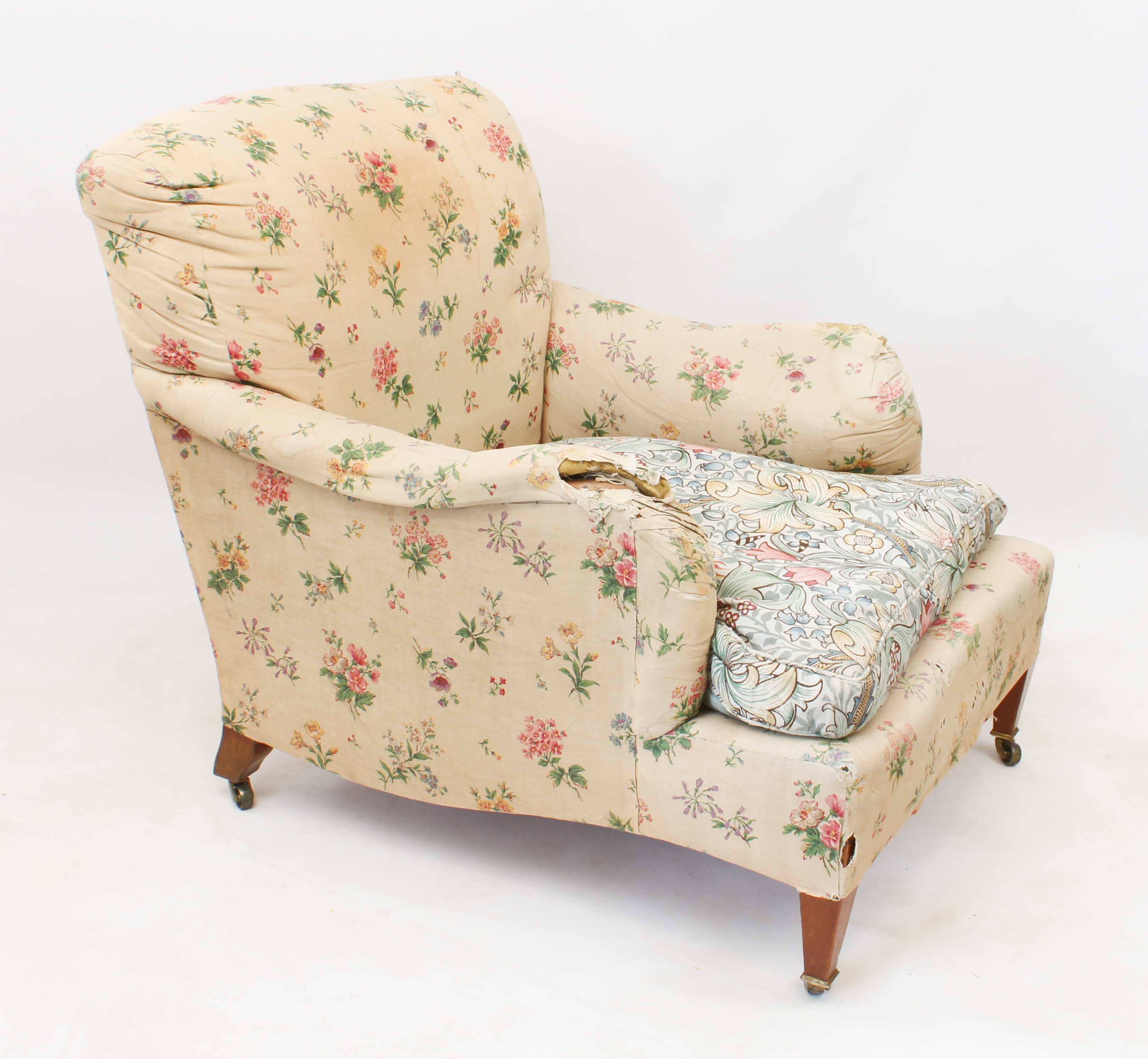 An early 20th century armchair by Howard & Sons - upholstered in early 20th century printed floral