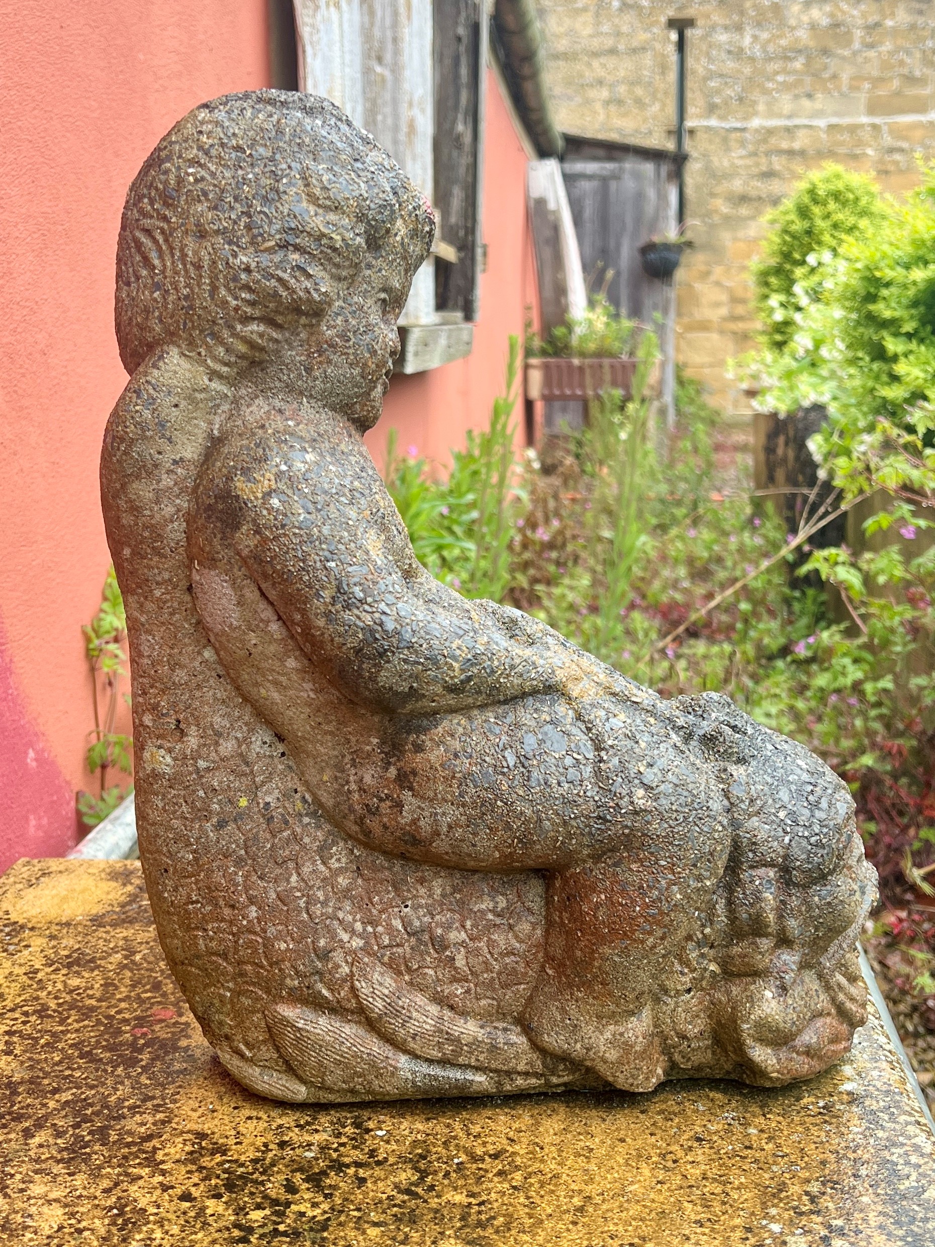 A composite stone garden statue of a child astride a dolphin - 29 x 15cm, 39cm high. - Bild 3 aus 3