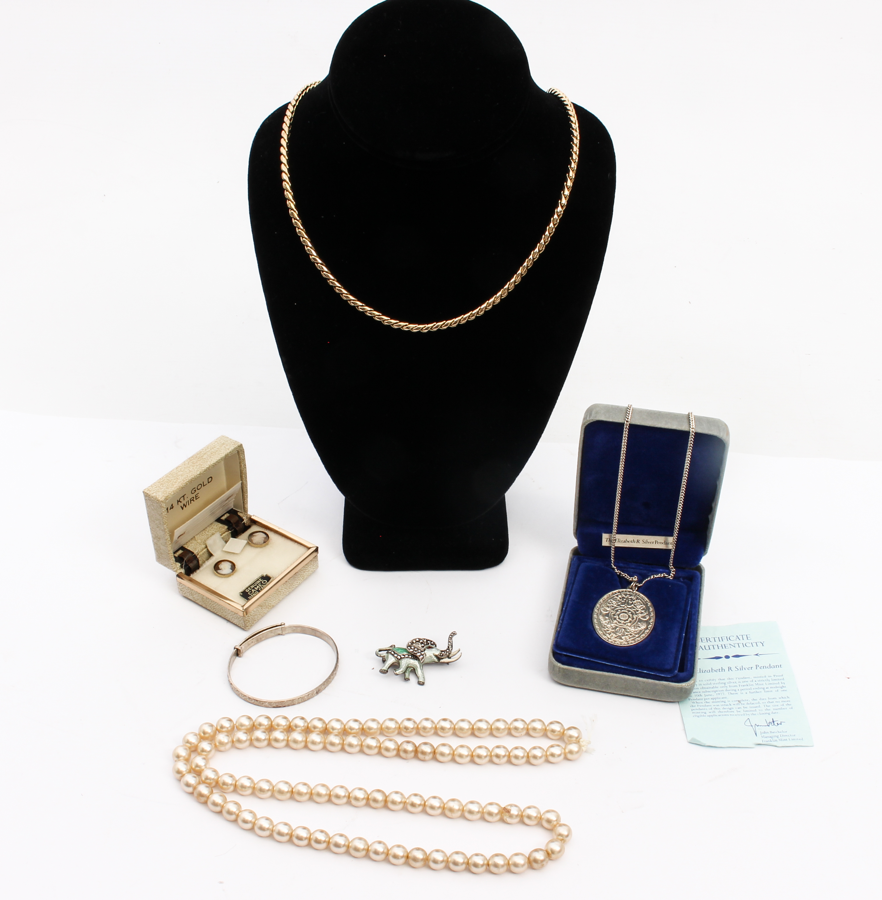 A small group of silver and costume jewellery - comprising a cased silver 'The Elizabeth R Silver