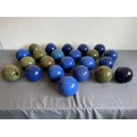 Twenty-two glazed terracotta decorative balls or spheres, for garden use - the majority glazed in