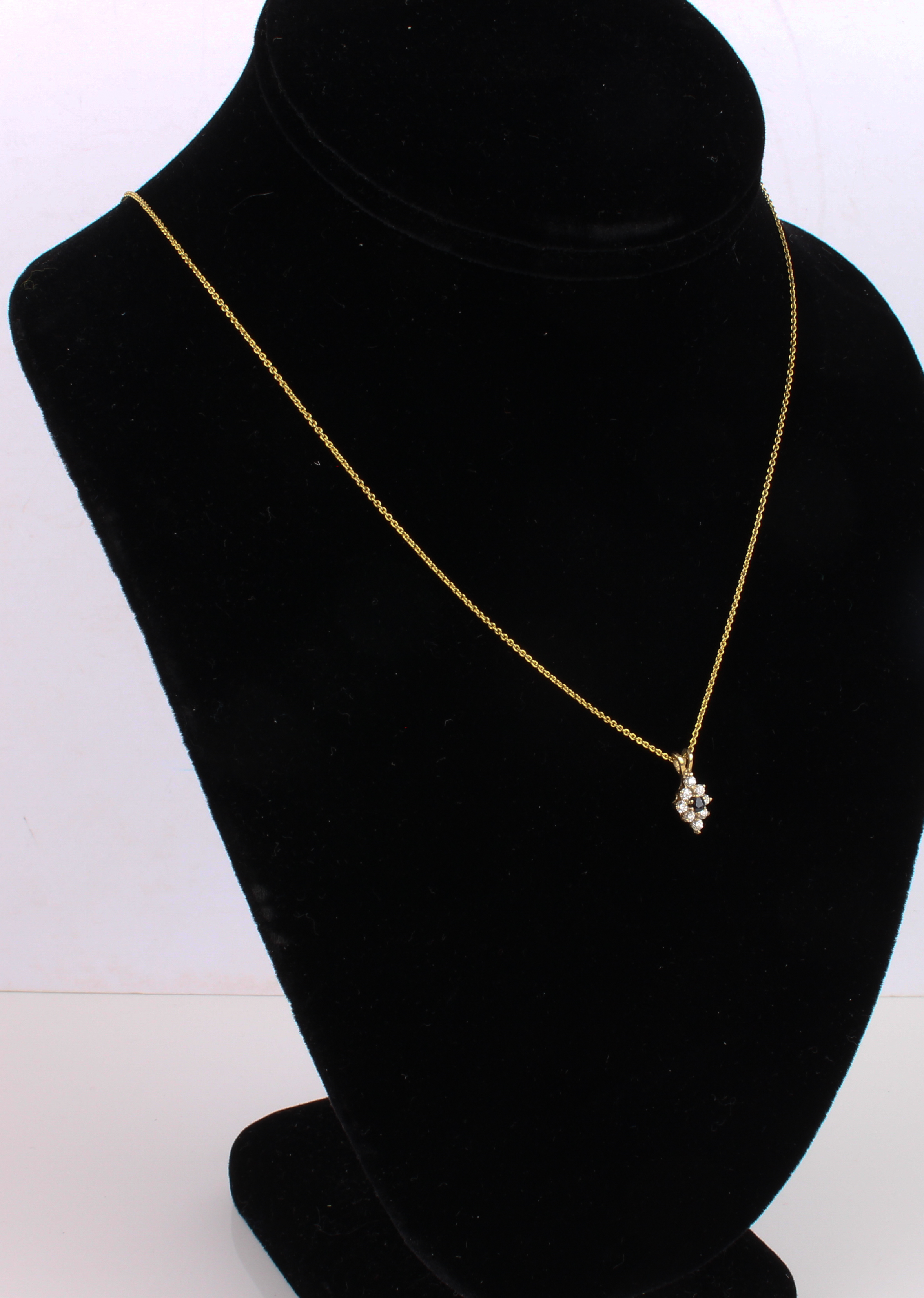 A 9ct yellow gold, sapphire and white stone pendant necklace - the pendant 14.5mm drop, overall