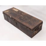 An early 20th century tin uniform trunk - the japanned exterior with remnants of travel labels and