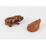 A carved fruitwood Okimono of a pig, plus a carved and signed netsuke of a Mandarin duck.