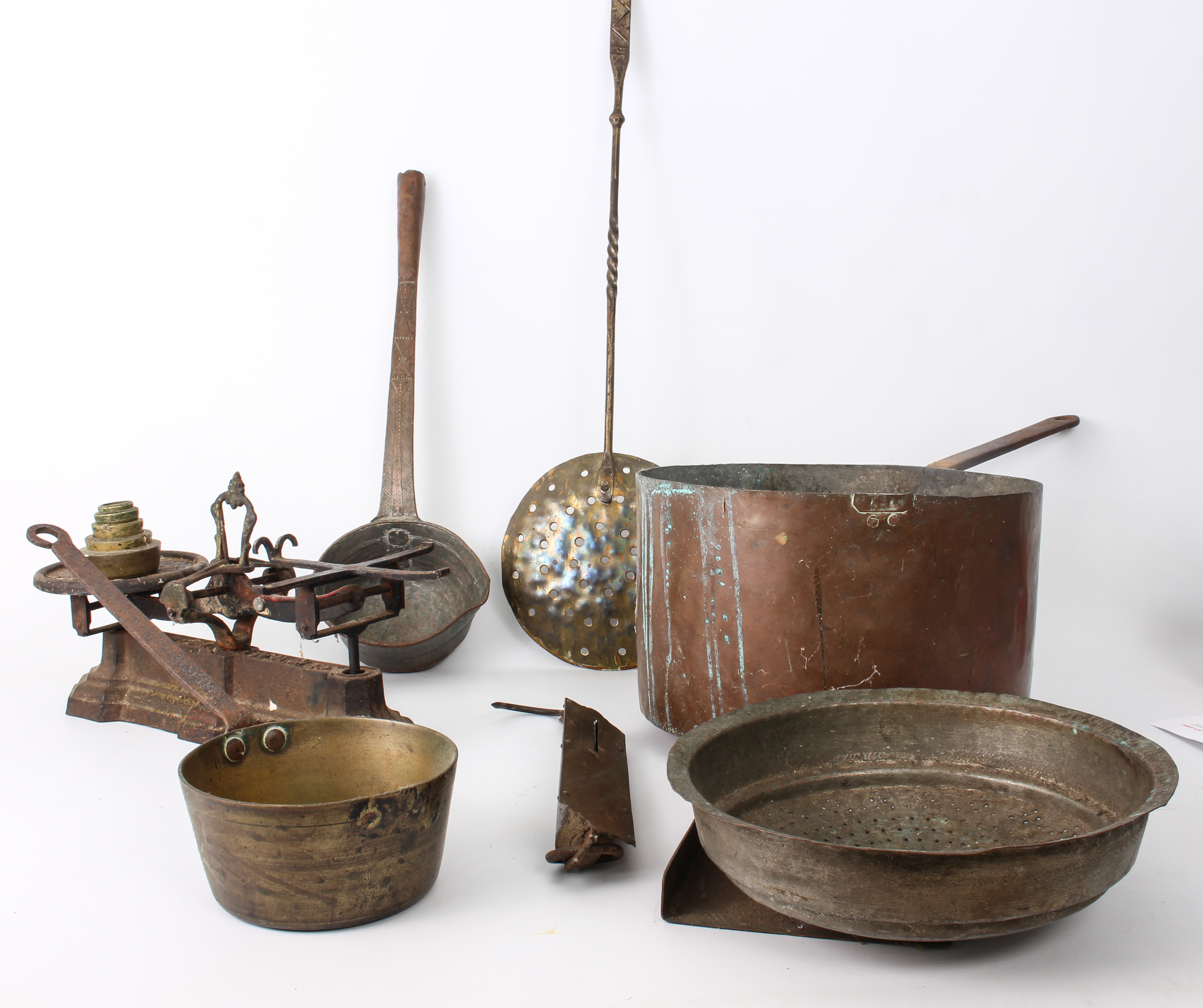 Seven pieces of copper and brass ware: a large copper and wrought iron 30 cm sauce pan; a smaller