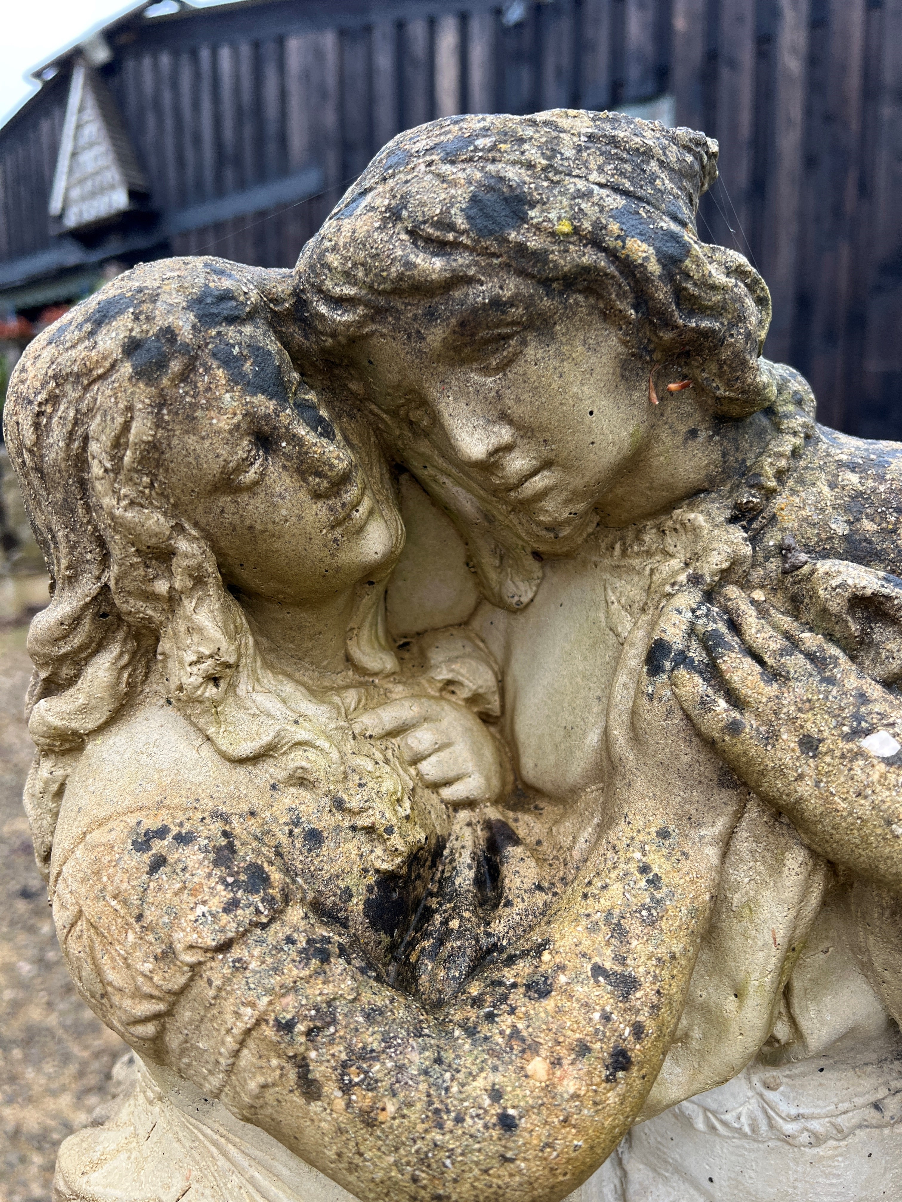 A composite stone statue of a young couple embracing - 70cm high. - Image 2 of 3