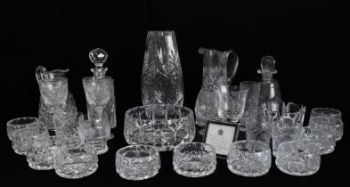 A collection of cut glass and crystal to include a vase, fruit bowl, two decanters, jugs, and