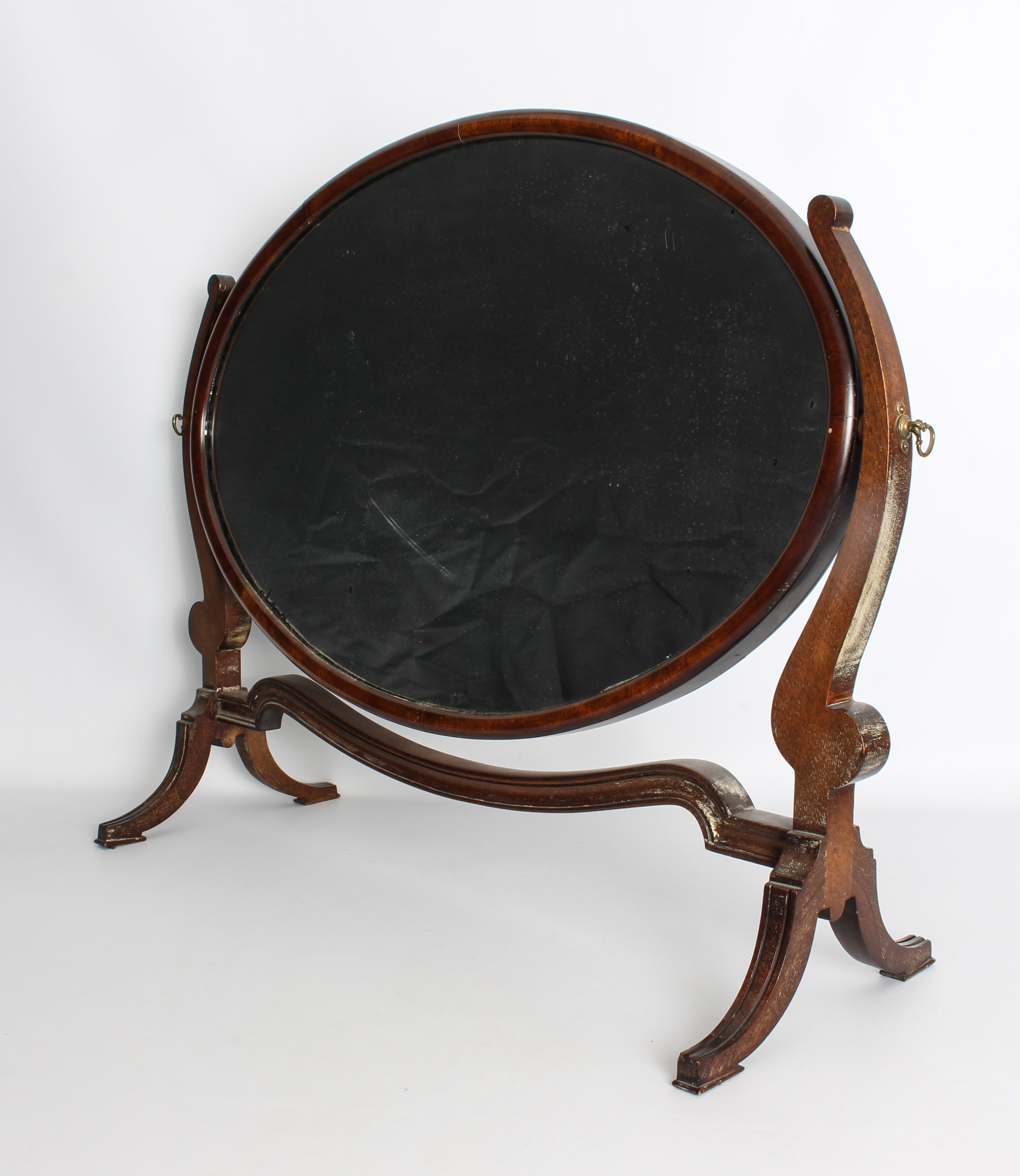 A Georgian-style oval mahogany swing mirror - 1920s, 56 cm wide, 71.5 cm high.