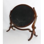 A Georgian-style oval mahogany swing mirror - 1920s, 56 cm wide, 71.5 cm high.