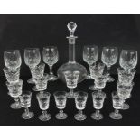 A matched set of cut glassware including sherry and liqueur glasses and a decanter.