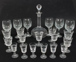 A matched set of cut glassware including sherry and liqueur glasses and a decanter.
