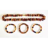 A Baltic amber necklace - with naturalistic beads in various colours, with screw clasp, 62.5 cm