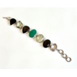 A silver and multigem bracelet - the seven faceted stones including a green agate, smoky quartz,