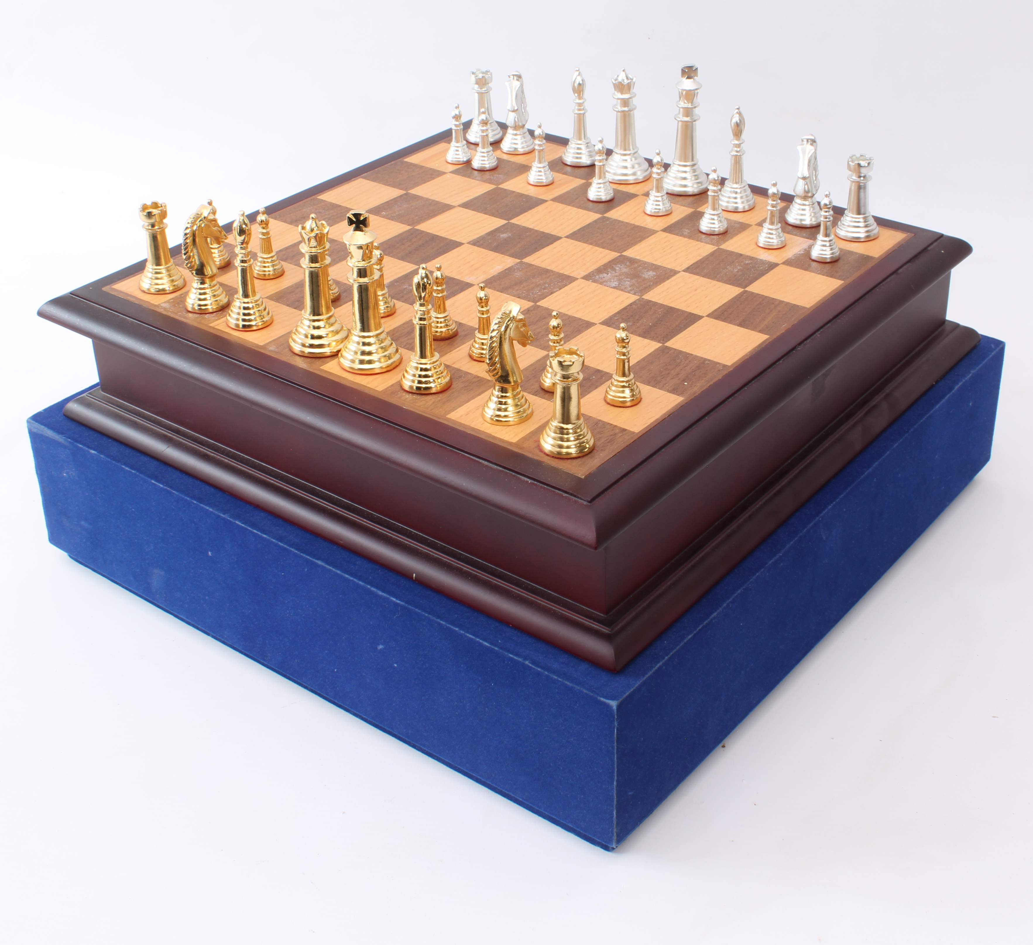 A cased chess set and board - late 20th century, the silver-coloured and gold-coloured cast metal
