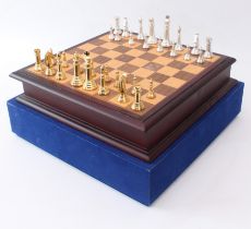 A cased chess set and board - late 20th century, the silver-coloured and gold-coloured cast metal