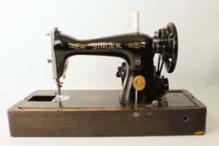 A cased Singer electric sewing-machine (EF305897)