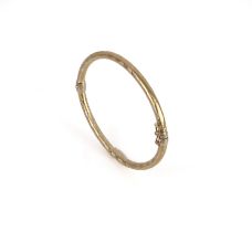 An Italian 9ct two-colour gold hinged bangle - marked 'Italy 9Kt', internal size 6.1 x 5.1 cm.