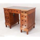 An Edwardian walnut double pedestal desk - the moulded top with inset gilt tooled green leather,