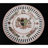 A Chinese porcelain armorial plate - 20th century, painted in the famille rose palette, with pierced