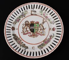 A Chinese porcelain armorial plate - 20th century, painted in the famille rose palette, with pierced