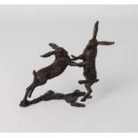 A bronze model of a pair of boxing hares, numbered 121/200, seal mark difficult to read, 11 x 14 cm.
