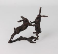 A bronze model of a pair of boxing hares, numbered 121/200, seal mark difficult to read, 11 x 14 cm.