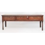 A late-18th century oak dresser base - the boarded top with applied half-round edge moulding, over