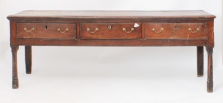 A late-18th century oak dresser base - the boarded top with applied half-round edge moulding, over