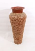 A very large floorstanding terracotta vase - with woven rattan exterior decoration, 98 cm high, a