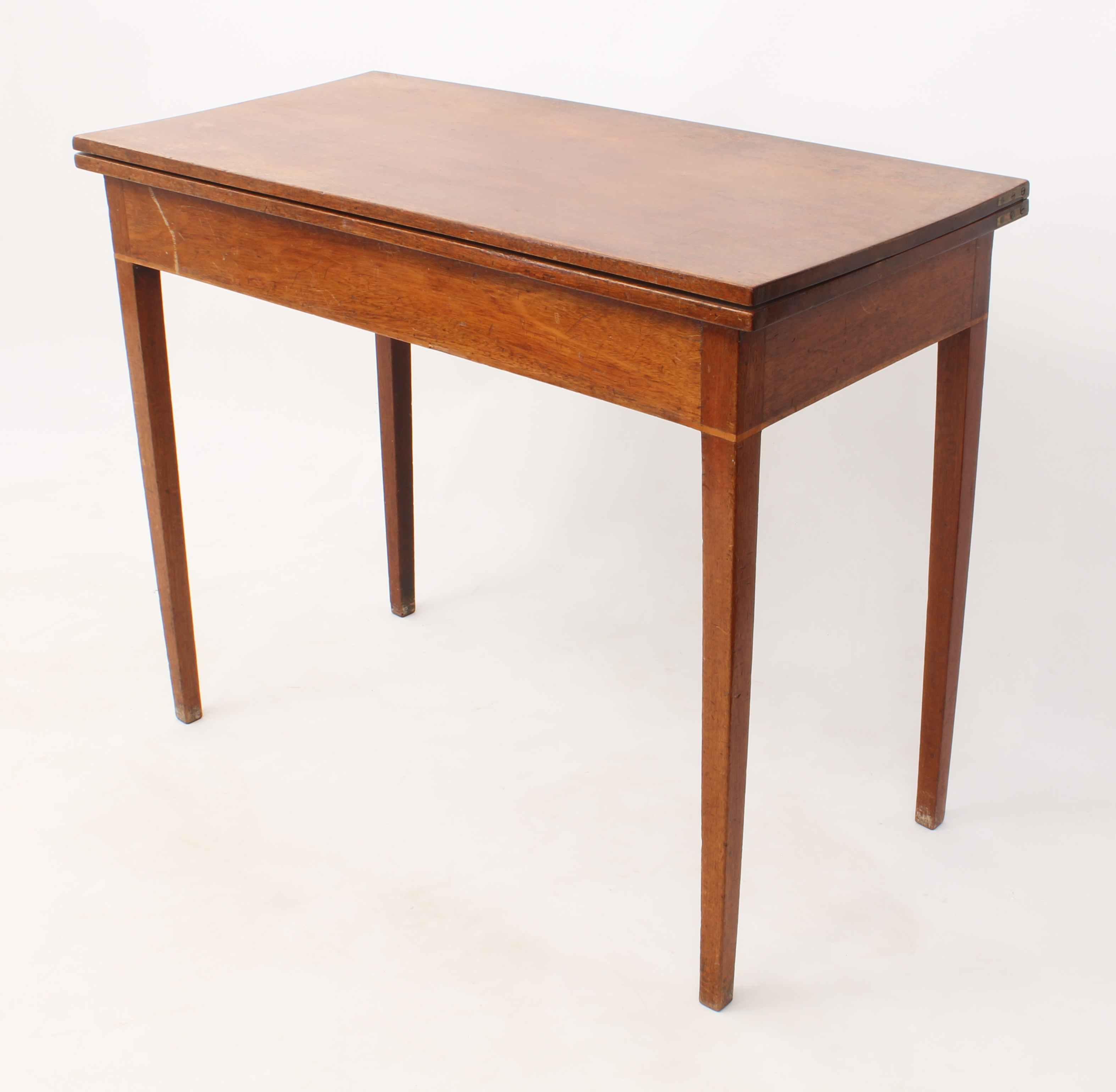 A mid-19th century mahogany rectangular fold-over tea table - with a boxwood edge banded frieze,