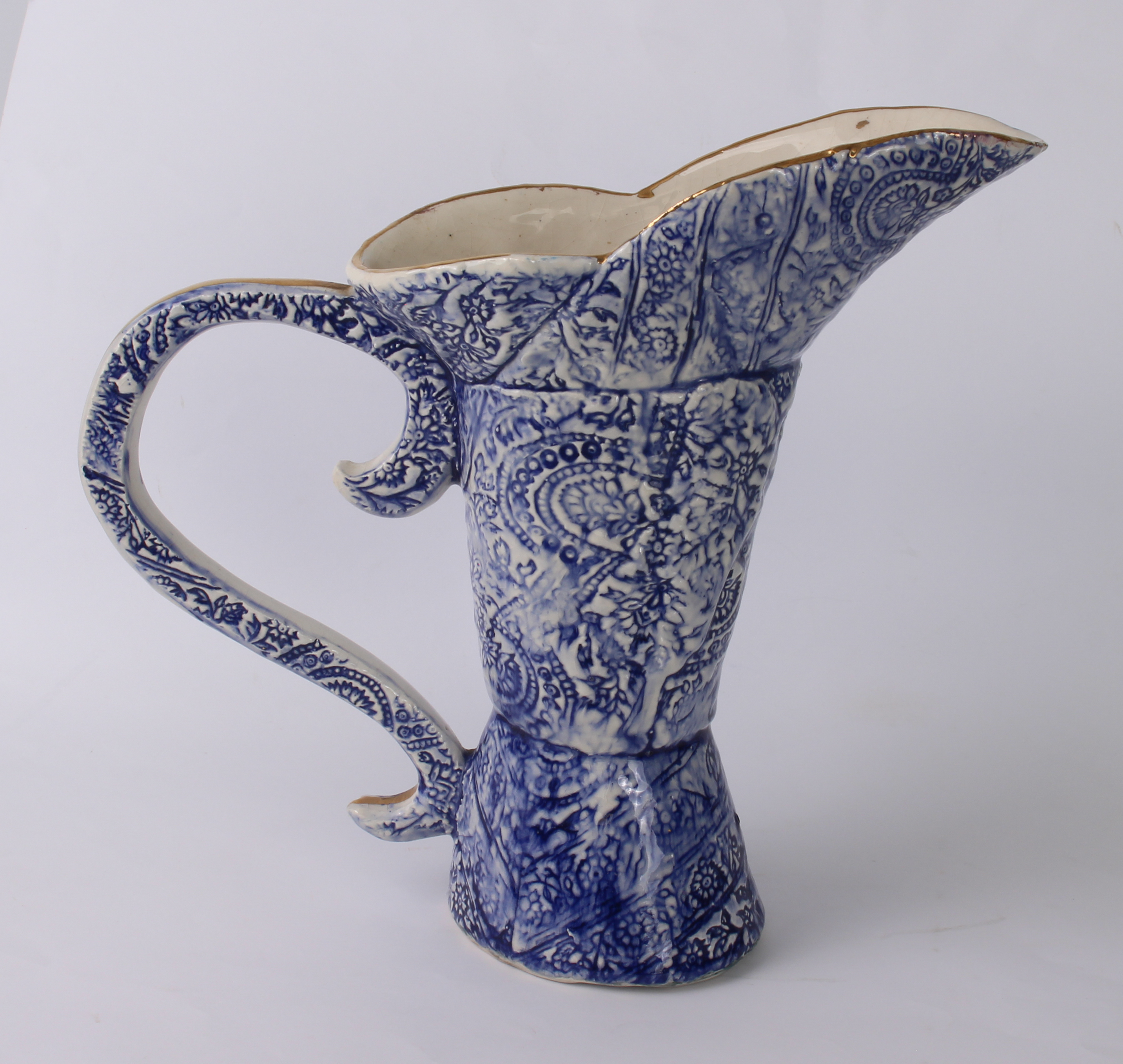 An unusual Continental blue and white pottery ewer - with three-part boot-shaped body and S-scroll