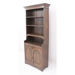 A small oak cupboard bookcase or miniature dresser - the stepped, ogee moulded cornice over four