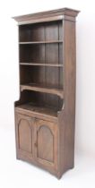 A small oak cupboard bookcase or miniature dresser - the stepped, ogee moulded cornice over four