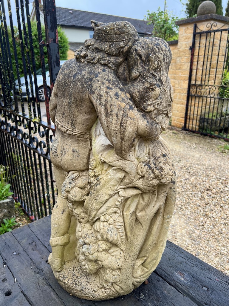 A composite stone statue of a young couple embracing - 70cm high. - Image 3 of 3