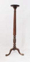 An early 20th century carved mahogany torchère - adapted from a 19th century bedpost, the dishes,