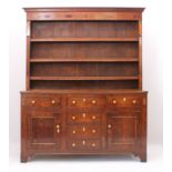 A George III oak, fruitwood and birds' eye maple inlaid dresser - the cavetto cornice over a