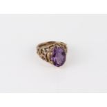 A vintage 9ct gold and amethyst ring - hallmarked 1978, the oval cut 13.5 x 9.5 mm amethyst claw-set