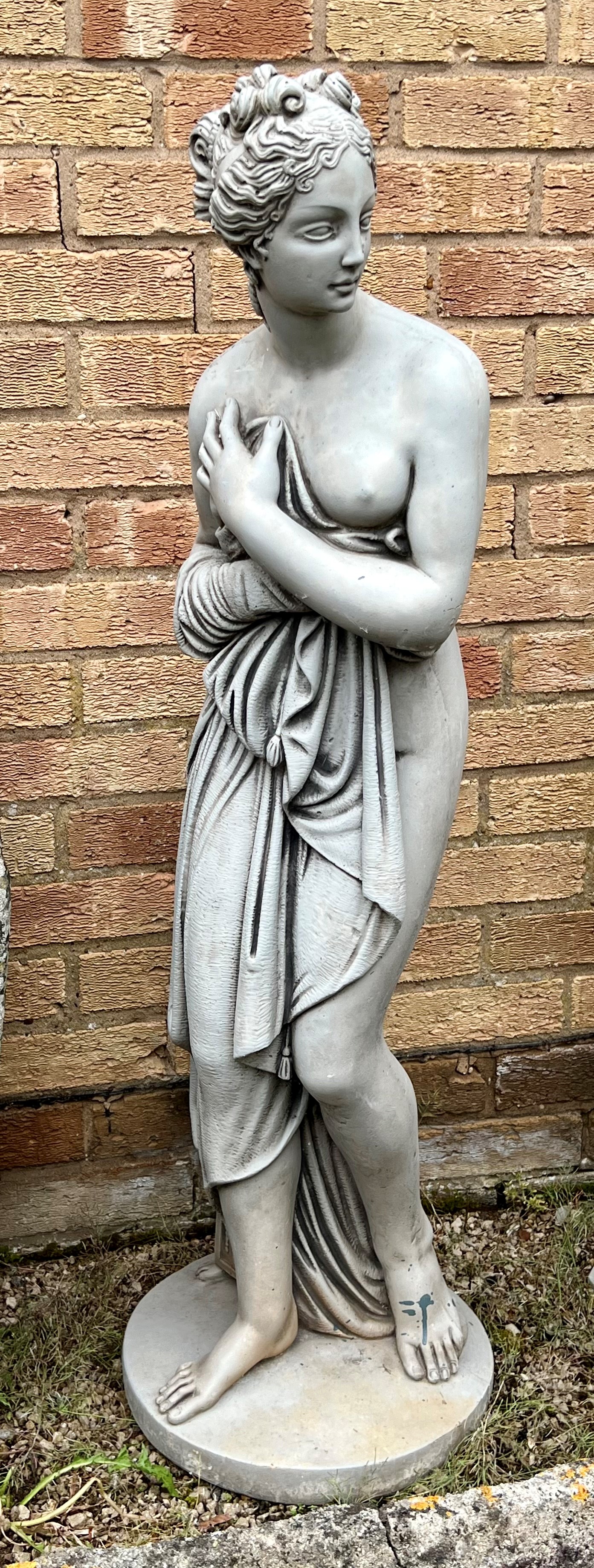 A moulded stone statue of a classical-style maiden with curls - 117cm high.