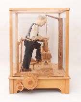 A fine carved wooden automaton of a woodworker, 'The Pole Lathe' - late 20th century, the carved